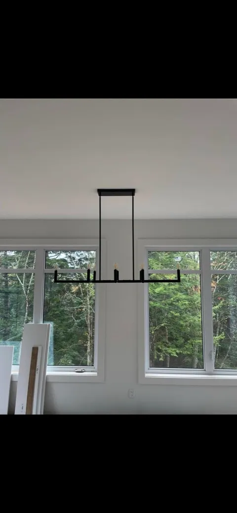 Linear dining fixture hung in a new build