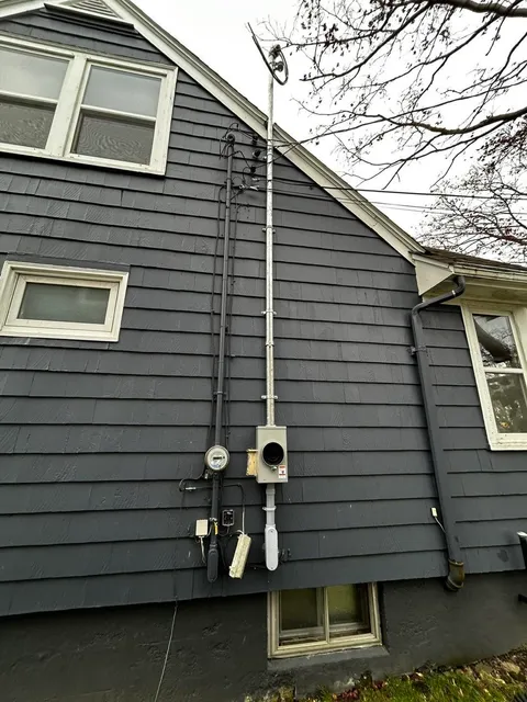 Completed service change with new mast, meter and exterior conduit